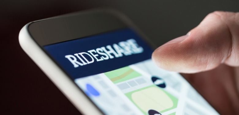 person requesting ride share services on phone | Coastline Realty