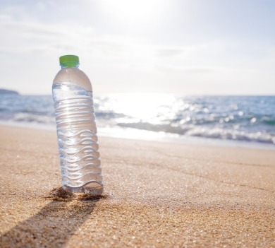 water bottle on beach | Coastline Realty Vacations