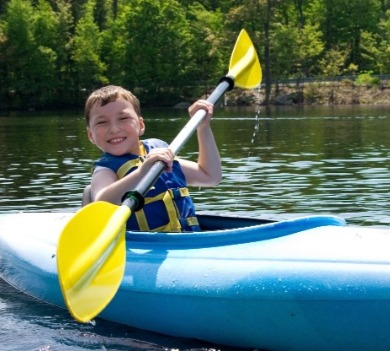 child kayaking in topsail, nc | Coastline Realty Vacations